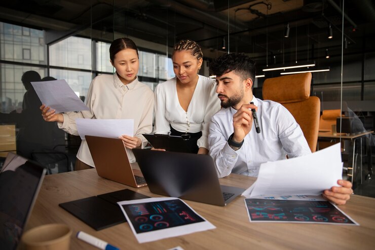 office workers using finance graphs_23 2150408651
